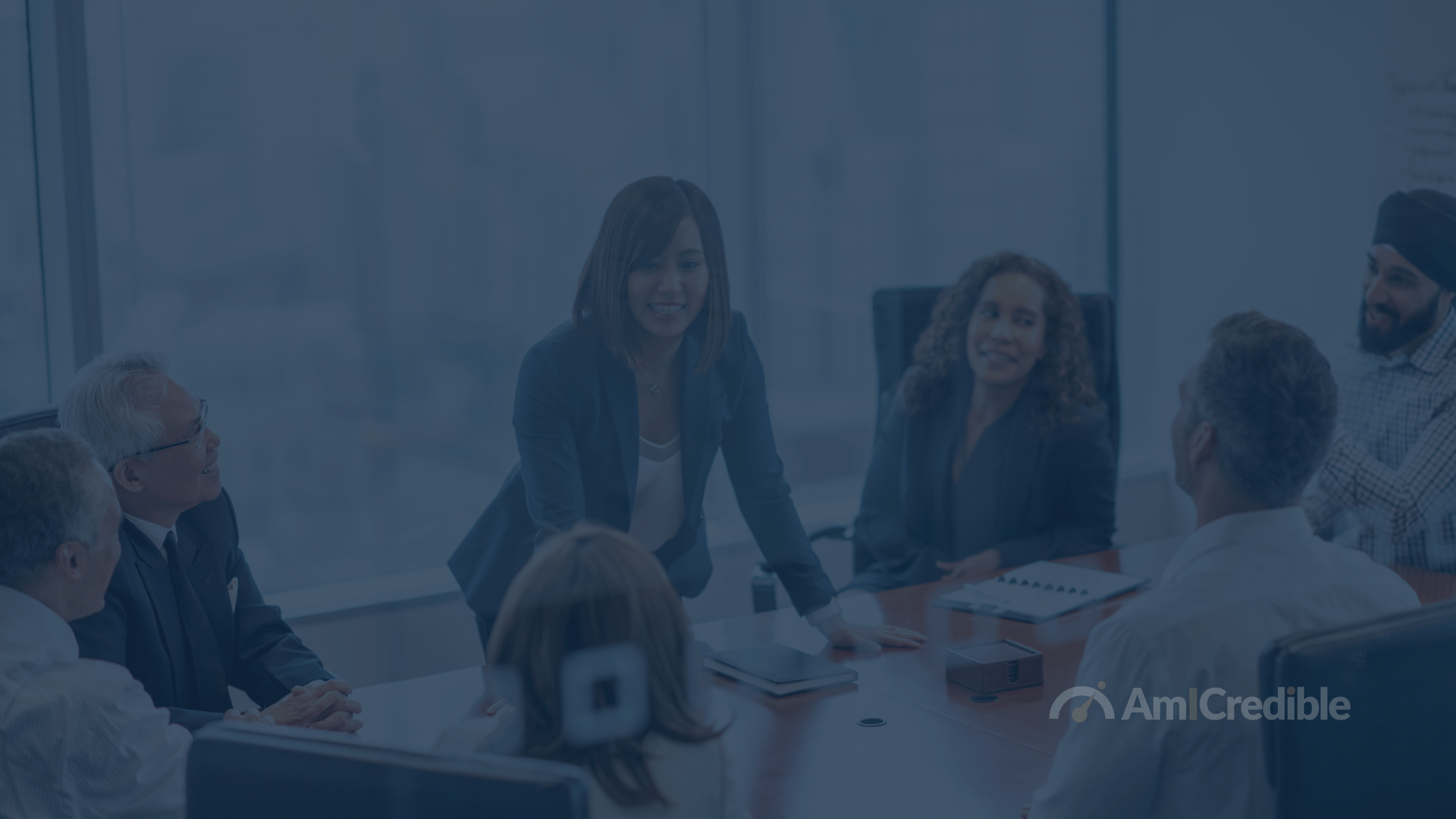 Lady speaking to people in a board room