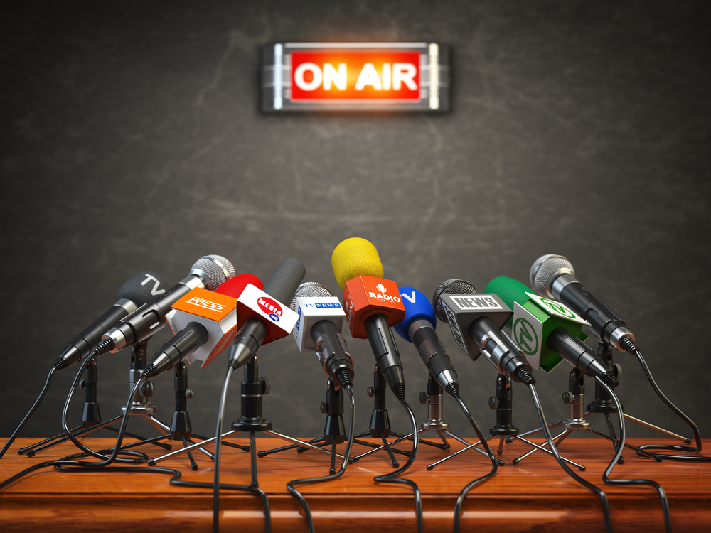 A group of microphones with an on the air sign